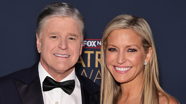 Sean Hannity smiling next to Ainsley Earhardt