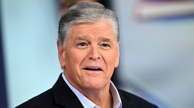 Sean Hannity with short gray hair looking directly ahead with a neutral expression