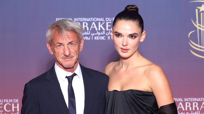 Sean Penn posing on the red carpet with his girlfriend Valeria Nicov at an event
