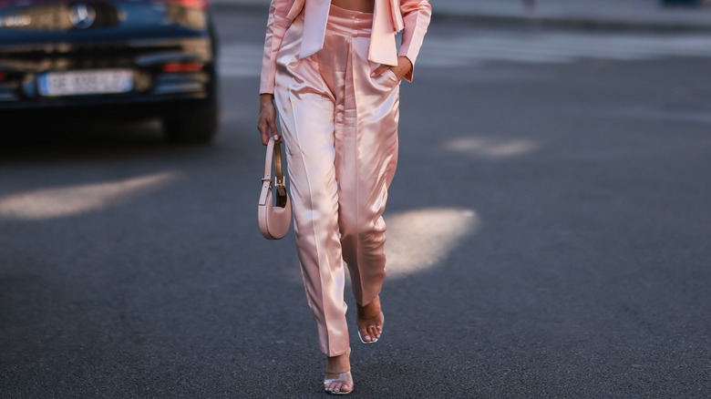 Woman in pink outfit wearing clear heels
