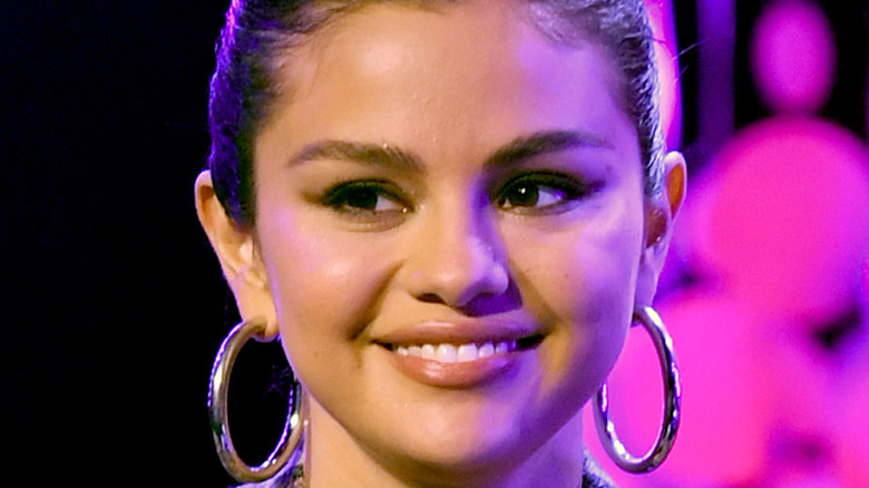Selena Gomez smiles onstage at an event