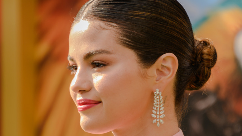 Selena Gomez with sleek bun smiling 