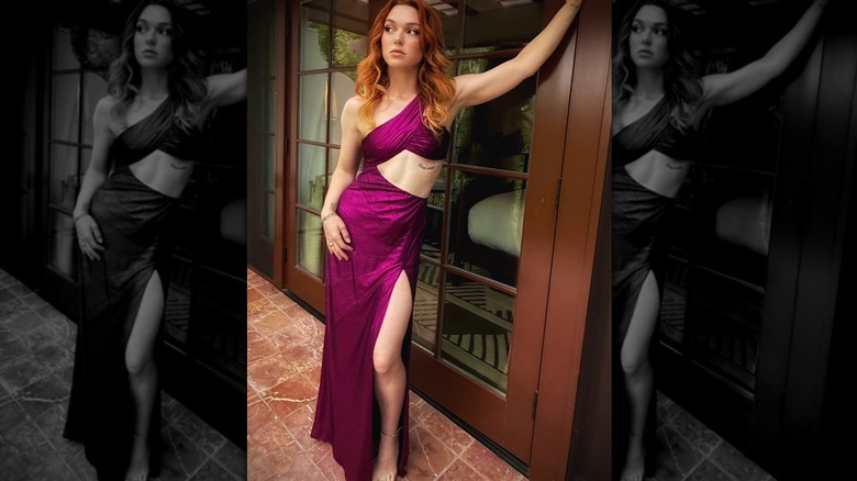 Jennifer Stone in a purple dress, leaning against a door.