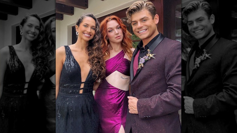 Maiara Walsh wearing a shiny black dress arm-in-arm with Jennifer Stone and Garrett Clayton, all smiling.
