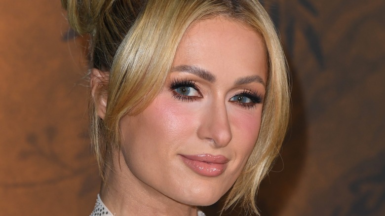 A close-up image of Paris Hilton smizing on the red carpet in 2025.