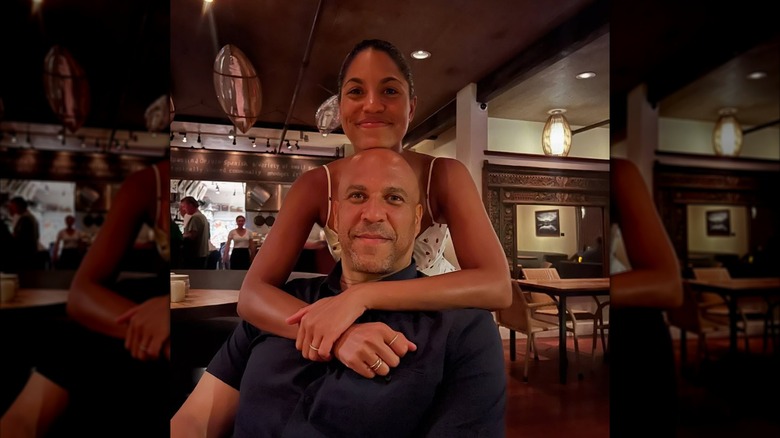 Alexis Lewis standing with her arms around Cory Booker