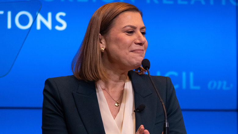 Elissa Slotkin delivering a speech onstage in a black blazer and white top