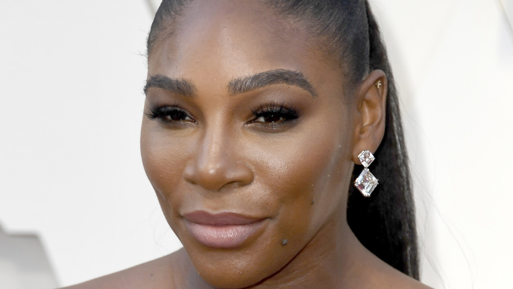 Serena Williams grinning with diamond earrings