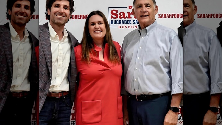 Sarah Huckabee Sanders posing in a red dress