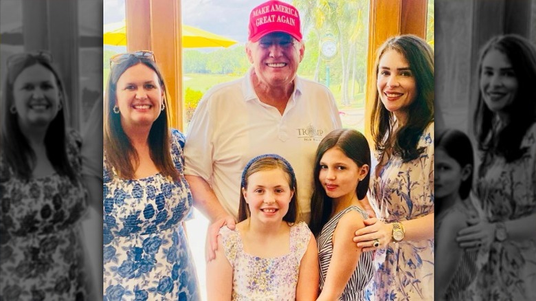 Sarah Huckabee Sanders posing with her family and Donald Trump