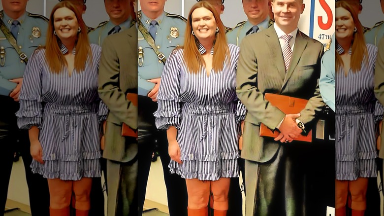 Sarah Huckabee Sanders in a blue stripe mini dress and brown boots