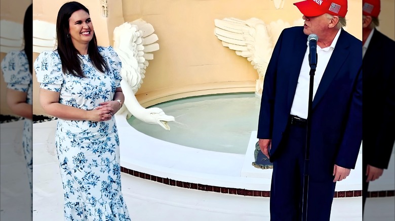 Sarah Huckabee Sanders wearing a blue floral dress while talking to Donald Trump