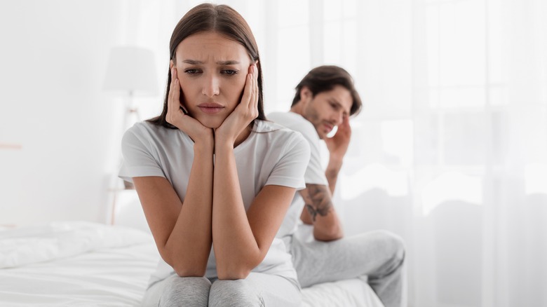 unhappy couple on bed