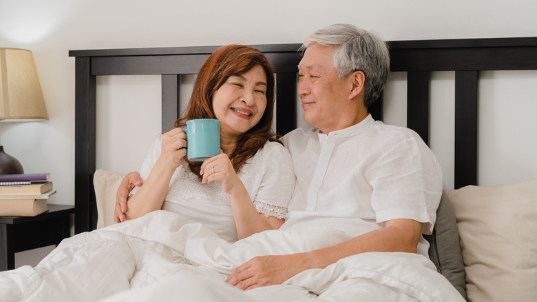 senior Asian couple in bed