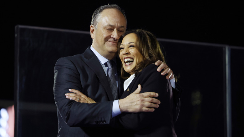 Kamala Harris is embraced by second gentleman Doug Emhoff after she spoke at a campaign rally on the Ellipse on October 29, 2024 in Washington, DC.