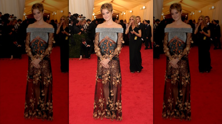 Shailene Woodley smiling with her hands clasped in front of her