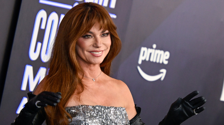 Shania Twain smiling and holding up her hands
