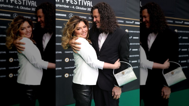 Frédéric Thiébaud hugs Shania Twain and smiles at her