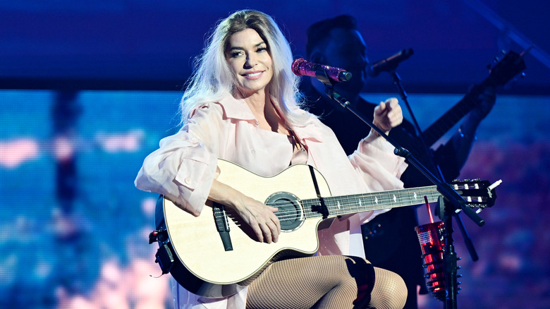 Shania Twain sporting blonde-gray hair as she performs on stage