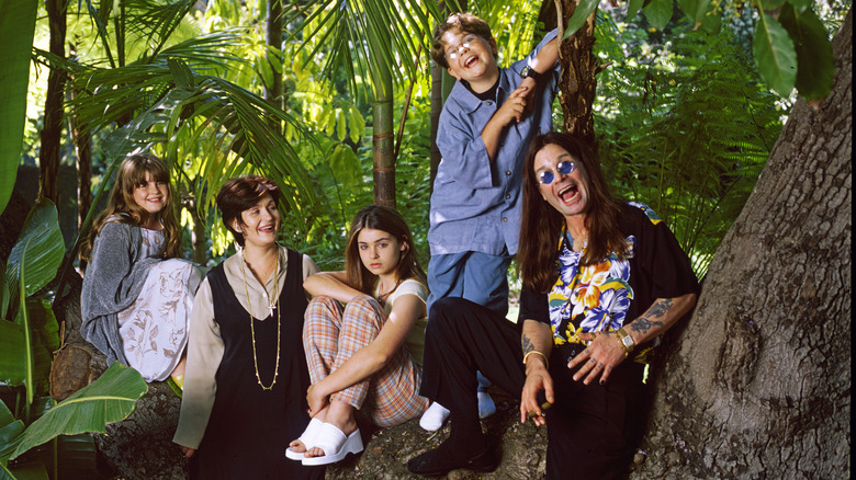 Sharon and Ozzy Osbourne smiling with their kids, Kelly, Aimee, and Jack Osbourne