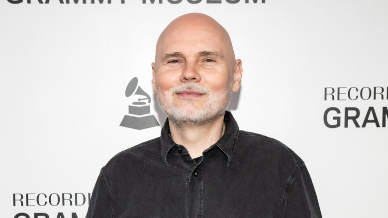 Billy Corgan posing in front of a white background