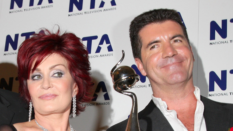 Sharon Osbourne mugging with Simon Cowell on the red carpet at the National Television Awards