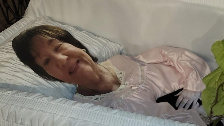 Cardboard cutout of Shelvy Neal in a casket