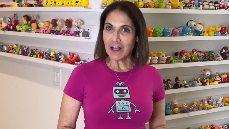 Marla Mogul in front of shelves of wind-up toys