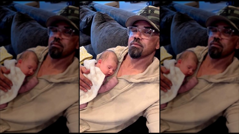 Photo of Shemar Moore cradling his newborn baby in 2023