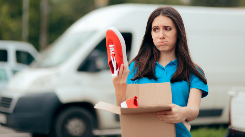 Woman opening box of shoes 