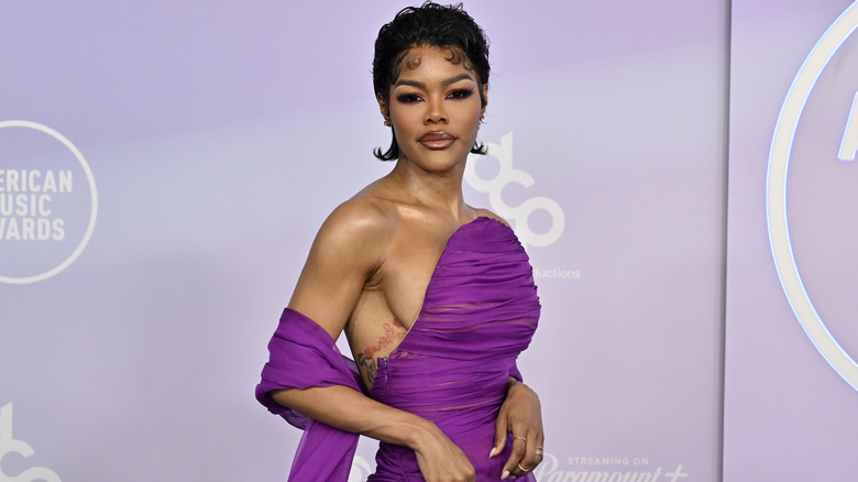 Teyana Taylor poses in a strapless purple gown