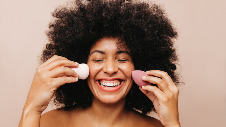 A happy woman with beauty blenders