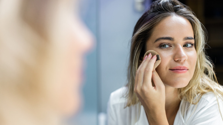 Woman applying makeup 