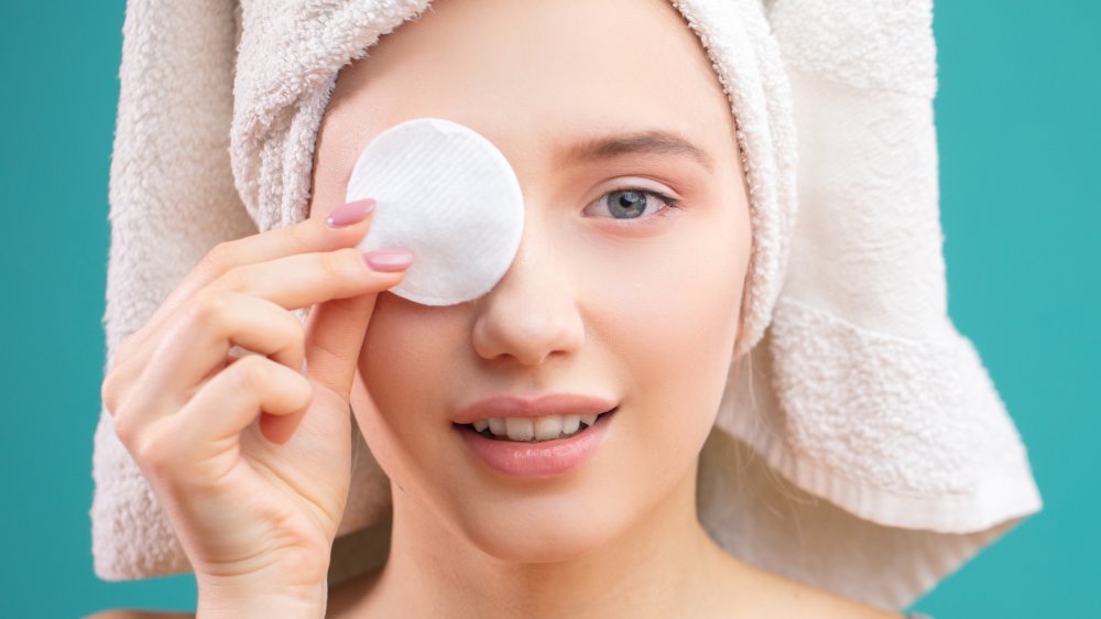 woman holding up a cleansing pad