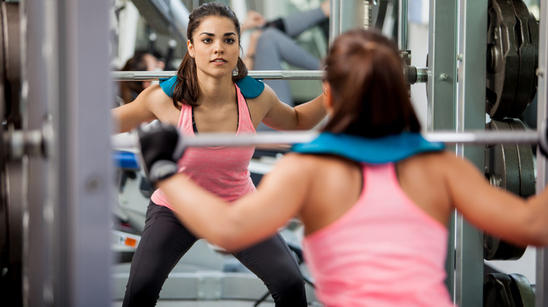 Doing squats at a mirror