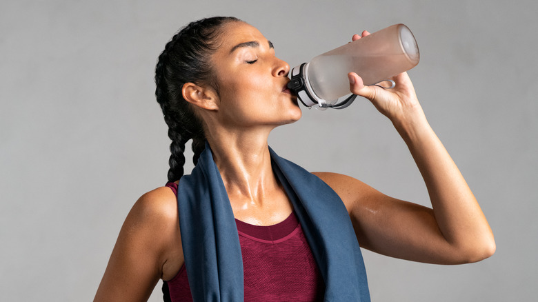 Woman drinking while working out 