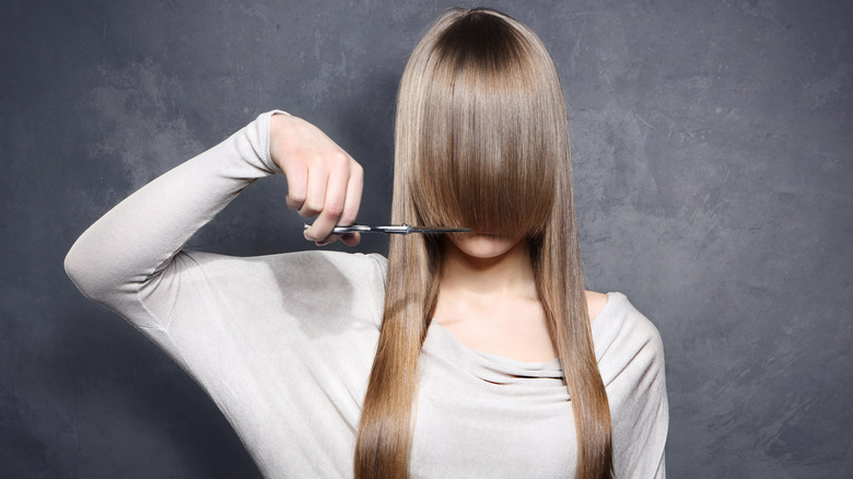 Person about to cut their long hair