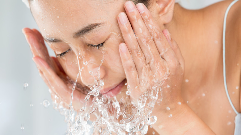 woman washing her face
