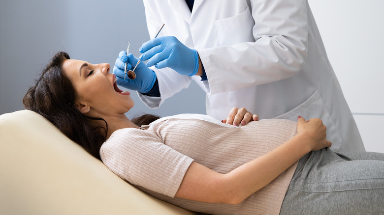 pregnant woman getting a dental exam