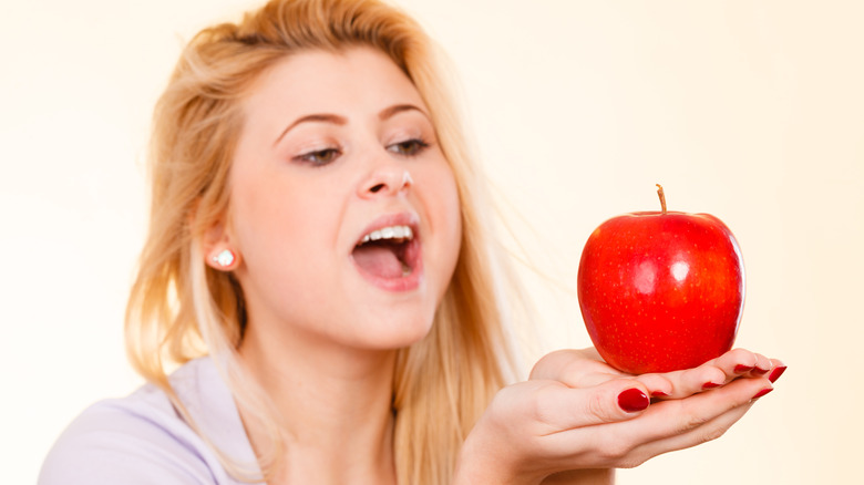 Apple lover admires her favorite food 