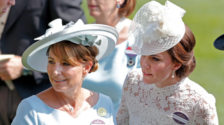 Carole Middleton and Catherine, Princess of Wales, both in light dresses with fascinators