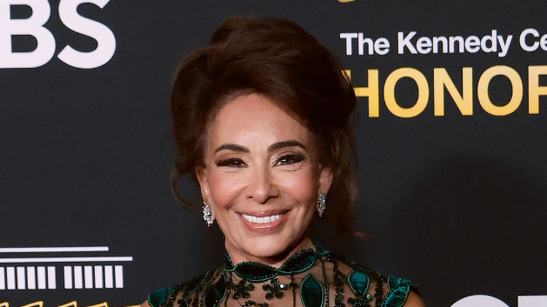 Jeanine Pirro smiling in a green and black dress