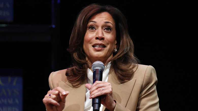 Kamala Harris holding a microphone on tour