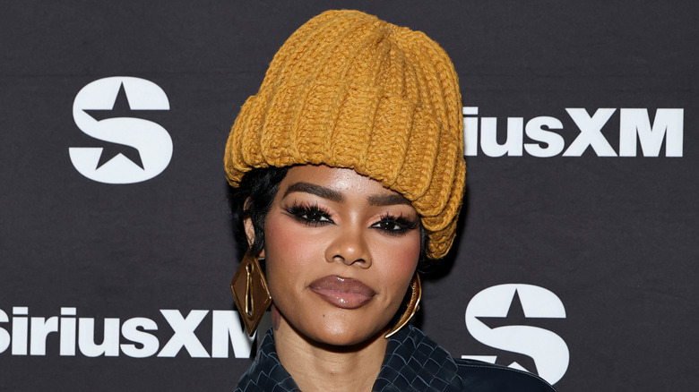 image of Teyana Taylor smiling and looking at the camera at the red carpet of an event