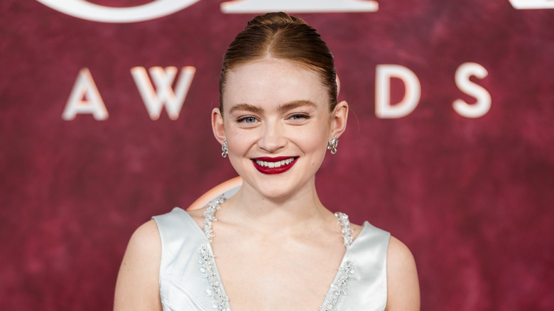 Sadie Sink posing at the Tony Awards in a silver dress