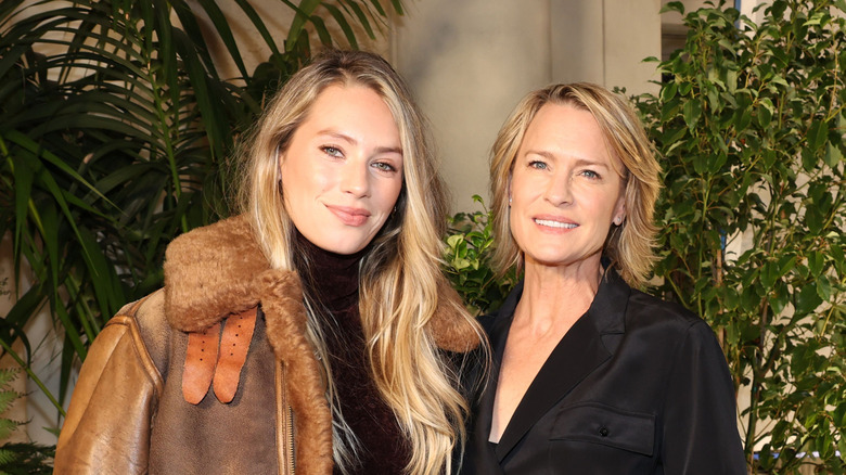 Dylan Penn with long hair and Robin Wright with a layered bob at the Ralph Lauren SS23 Runway Show.