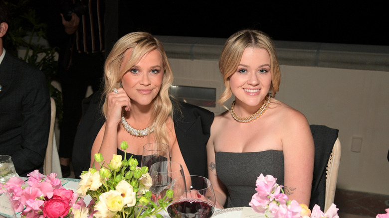 Reese Witherspoon and Ava Phillippe photographed seated at a table in April 2024.