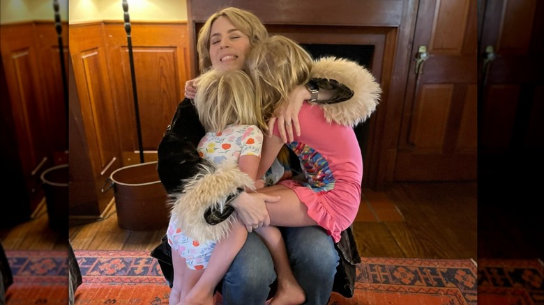 Erin Napier hugging her two daughters