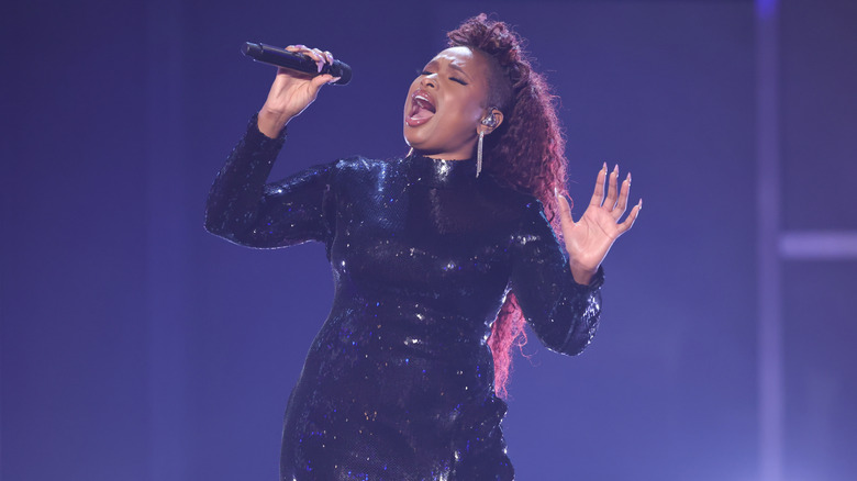 Jennifer Hudson singing on stage in a black sequin dress
