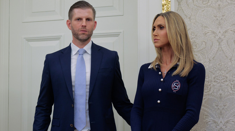 image of Eric Trump and Lara Trump side by side with bland expressions during a political event